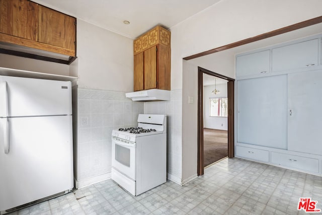 kitchen with tile walls and white appliances