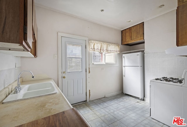 kitchen featuring sink and white appliances