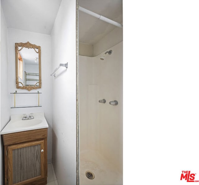 bathroom featuring vanity and a shower