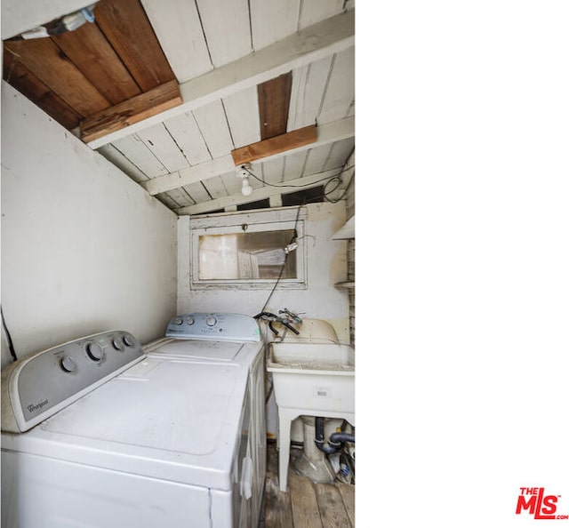 clothes washing area featuring separate washer and dryer, hardwood / wood-style floors, and wooden ceiling