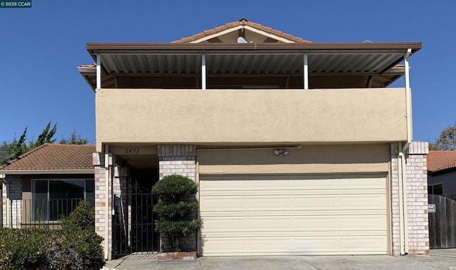 view of front of property with a garage and a balcony