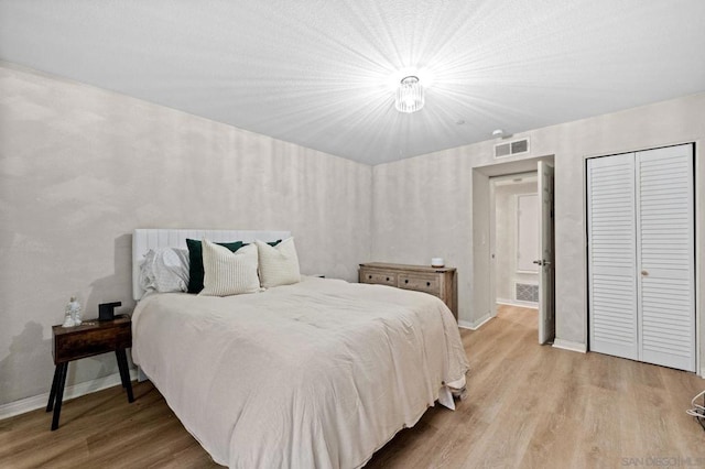 bedroom featuring light wood-type flooring and a closet