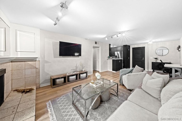 living room with track lighting and wood-type flooring