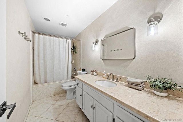 full bathroom with shower / bathtub combination with curtain, vanity, tile patterned floors, and toilet