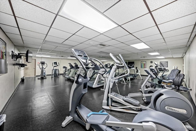 workout area with a paneled ceiling