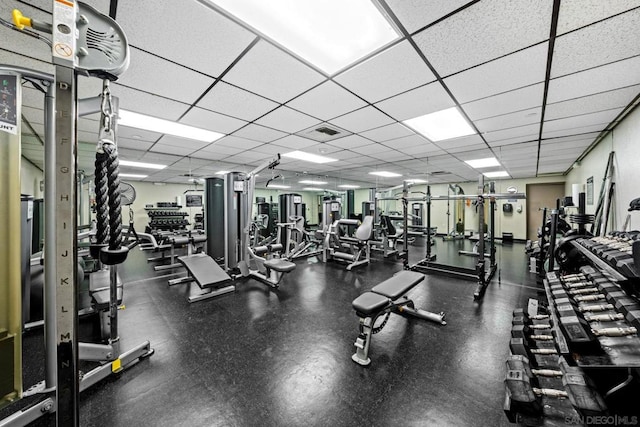 exercise room with a paneled ceiling