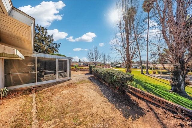 view of yard featuring a sunroom