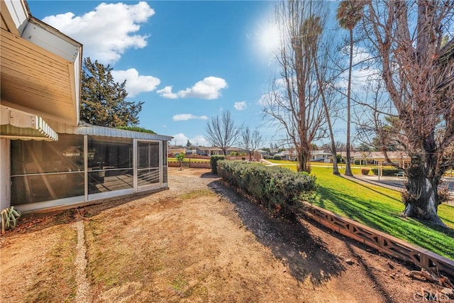 view of yard with a sunroom and a residential view