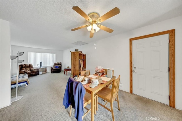 dining space with a ceiling fan, visible vents, a textured ceiling, and light colored carpet