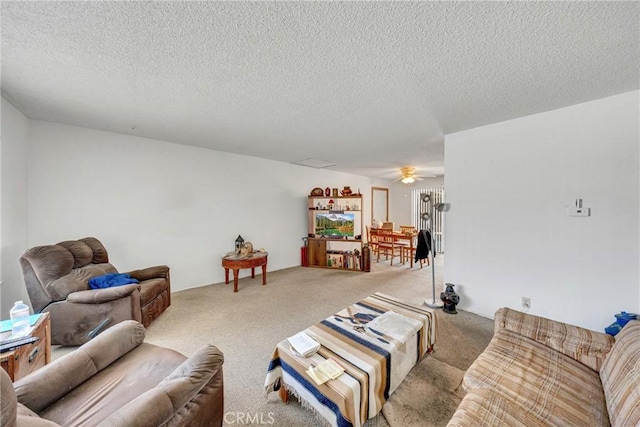 carpeted living room with ceiling fan and a textured ceiling