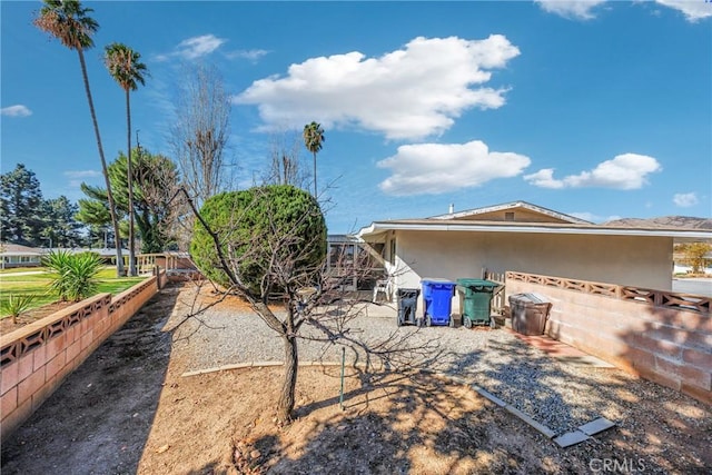 exterior space with fence and stucco siding
