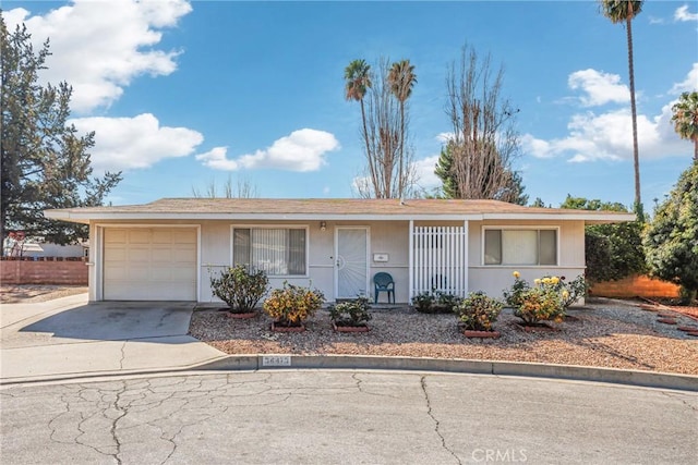 ranch-style house with an attached garage and driveway