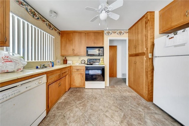 kitchen with tile countertops, sink, light tile patterned floors, ceiling fan, and white appliances