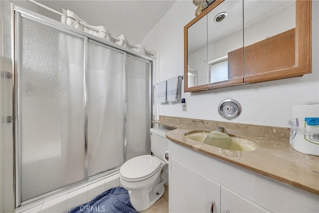 bathroom featuring an enclosed shower, vanity, tile patterned floors, and toilet