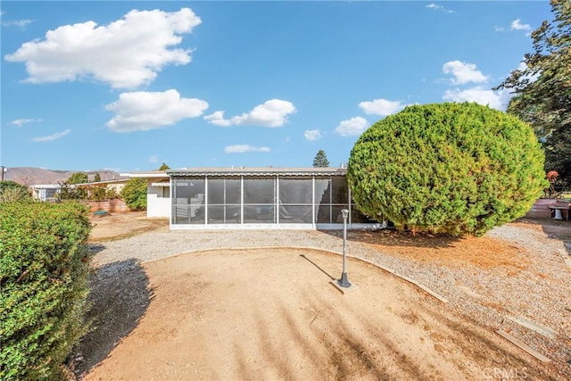 back of house featuring a sunroom