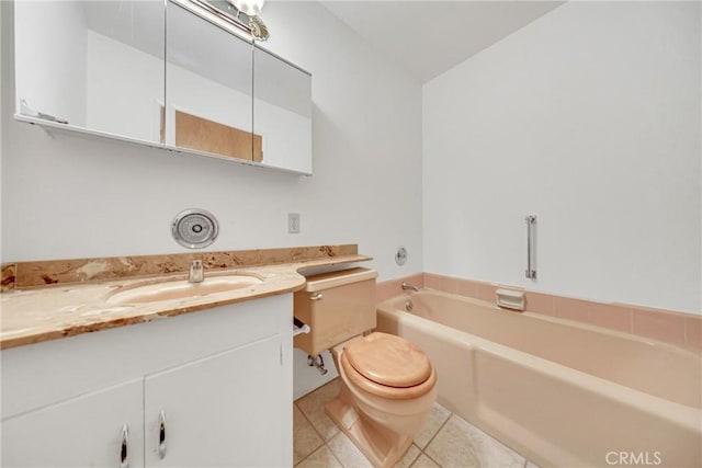 bathroom featuring tile patterned flooring, a bath, vanity, and toilet