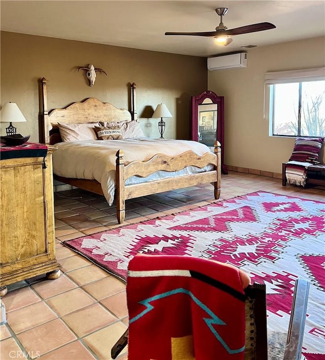 tiled bedroom with ceiling fan and a wall unit AC