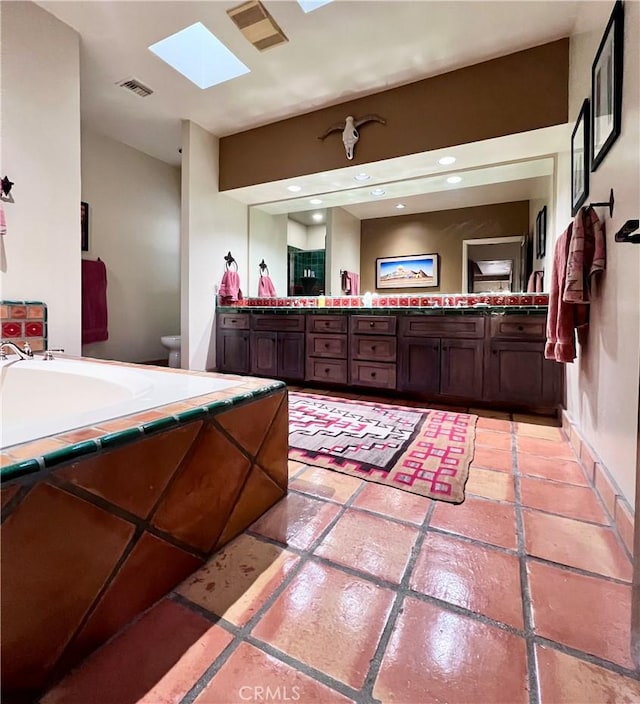 bathroom featuring vanity and a skylight