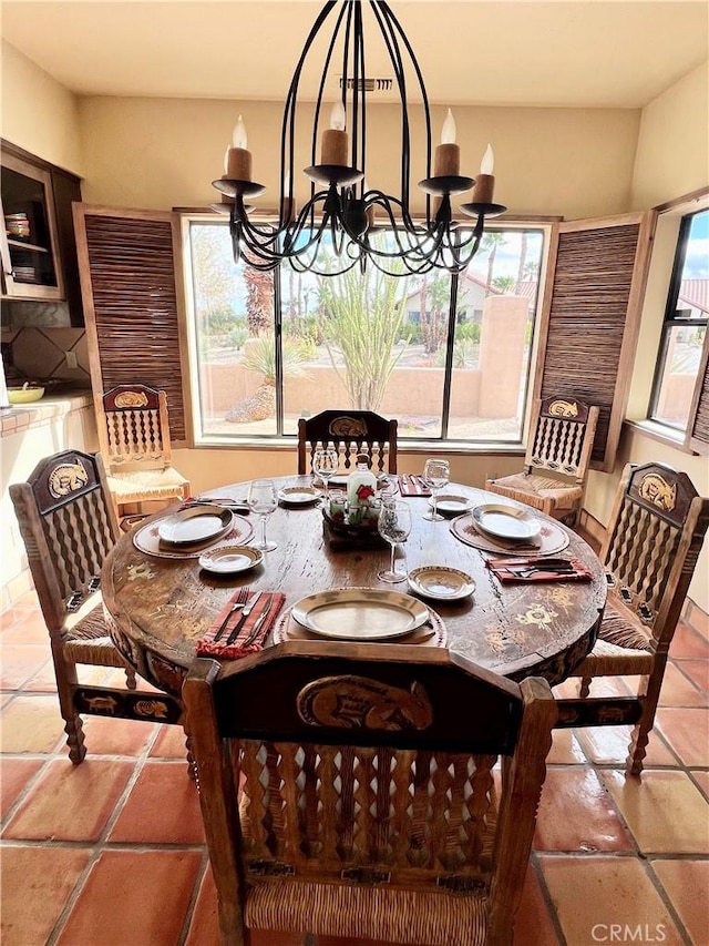 tiled dining space featuring a notable chandelier