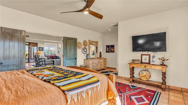 bedroom with a ceiling fan and light tile patterned flooring