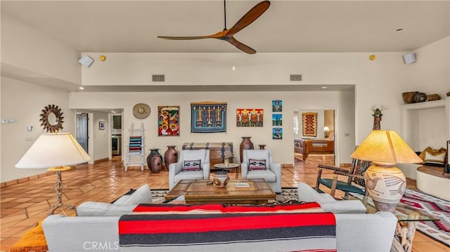 living room featuring a ceiling fan, visible vents, and light tile patterned floors