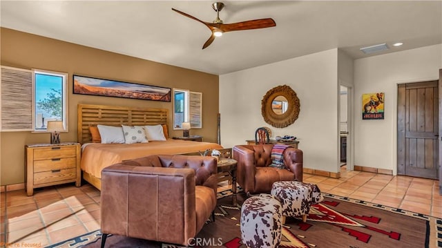 bedroom with a ceiling fan, visible vents, baseboards, and light tile patterned floors