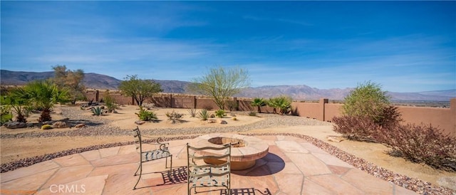 view of patio with a fenced backyard and a mountain view