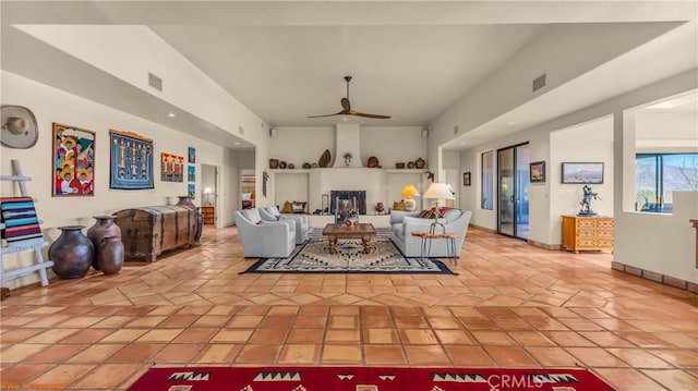 living room with ceiling fan, light tile patterned floors, visible vents, and baseboards