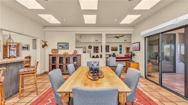 dining area featuring lofted ceiling, light tile patterned flooring, and a notable chandelier