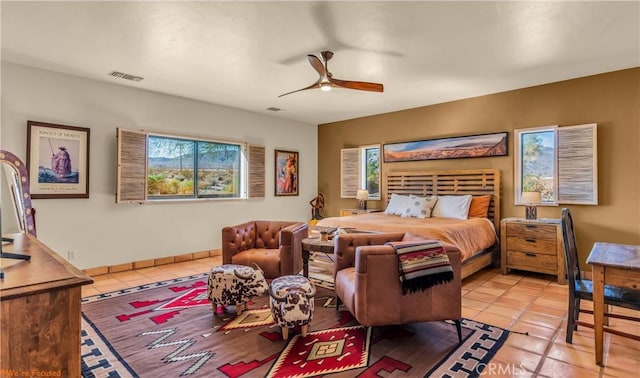 bedroom with a ceiling fan, visible vents, baseboards, and light tile patterned flooring