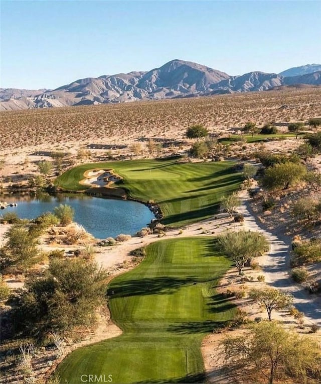 view of community featuring view of golf course and a water and mountain view