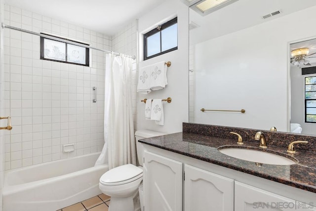 full bathroom featuring vanity, tile patterned flooring, toilet, and shower / bathtub combination with curtain