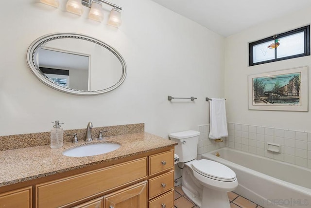 bathroom with vanity, tile patterned flooring, a bathtub, and toilet