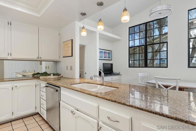 kitchen featuring white cabinetry, sink, stainless steel dishwasher, and hanging light fixtures