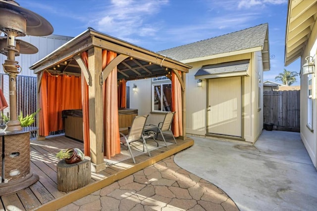 exterior space with a hot tub and a gazebo