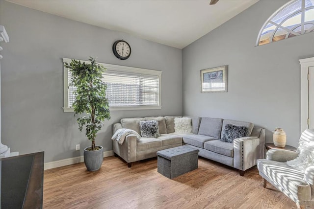 living room with ceiling fan, wood-type flooring, and vaulted ceiling