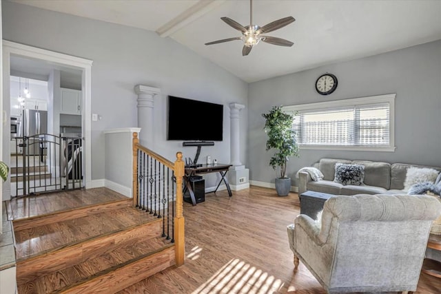 living room with vaulted ceiling with beams, light hardwood / wood-style floors, and ceiling fan