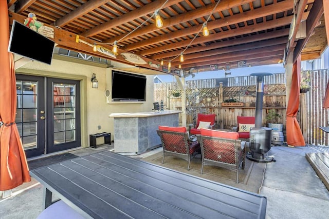 view of patio / terrace with an outdoor hangout area, an outdoor bar, and french doors