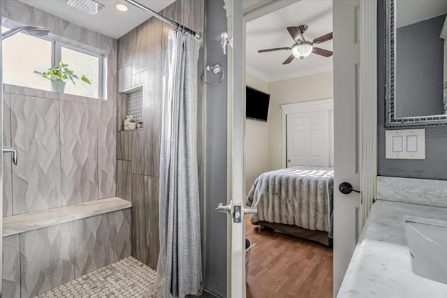 bathroom featuring crown molding, ceiling fan, wood-type flooring, and a shower with shower curtain