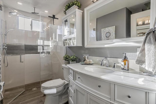 bathroom featuring vanity, an enclosed shower, and toilet