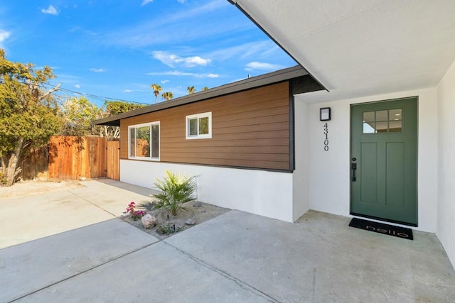 entrance to property featuring a patio