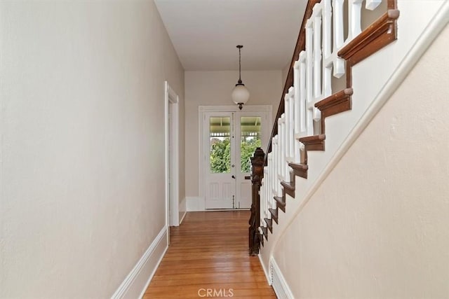 doorway to outside with french doors and light hardwood / wood-style floors