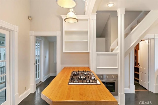 kitchen with stainless steel appliances, dark hardwood / wood-style flooring, and butcher block countertops