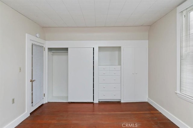 unfurnished bedroom featuring dark hardwood / wood-style floors