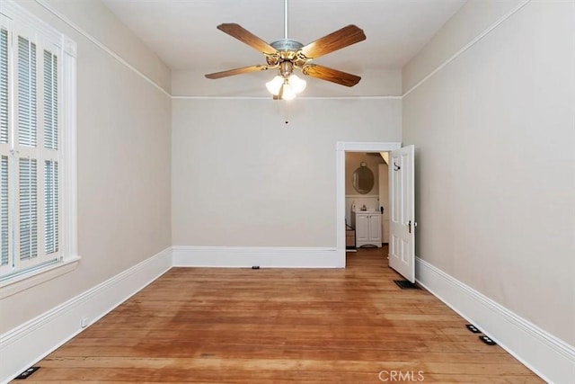 spare room with ceiling fan and hardwood / wood-style floors