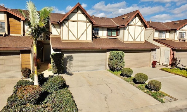 english style home featuring a garage