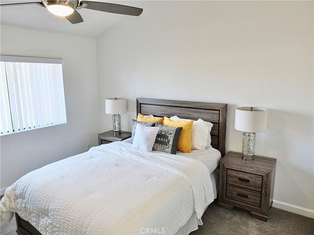 bedroom with dark colored carpet and ceiling fan