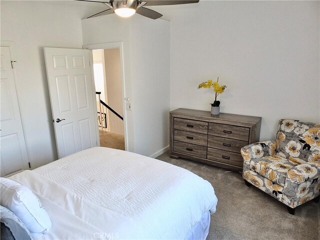 bedroom with ceiling fan and dark colored carpet