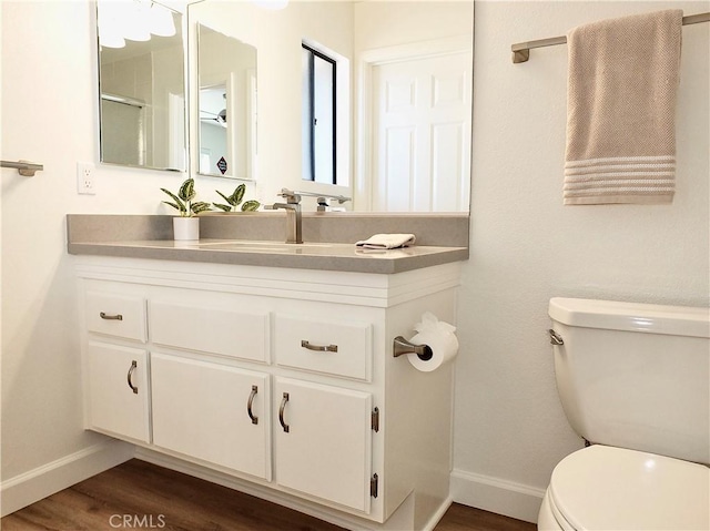 bathroom featuring vanity, hardwood / wood-style floors, and toilet