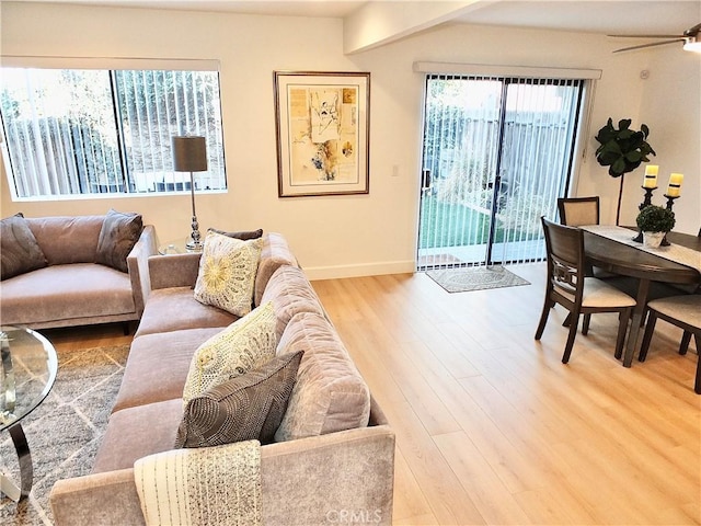 living room featuring light hardwood / wood-style flooring and ceiling fan